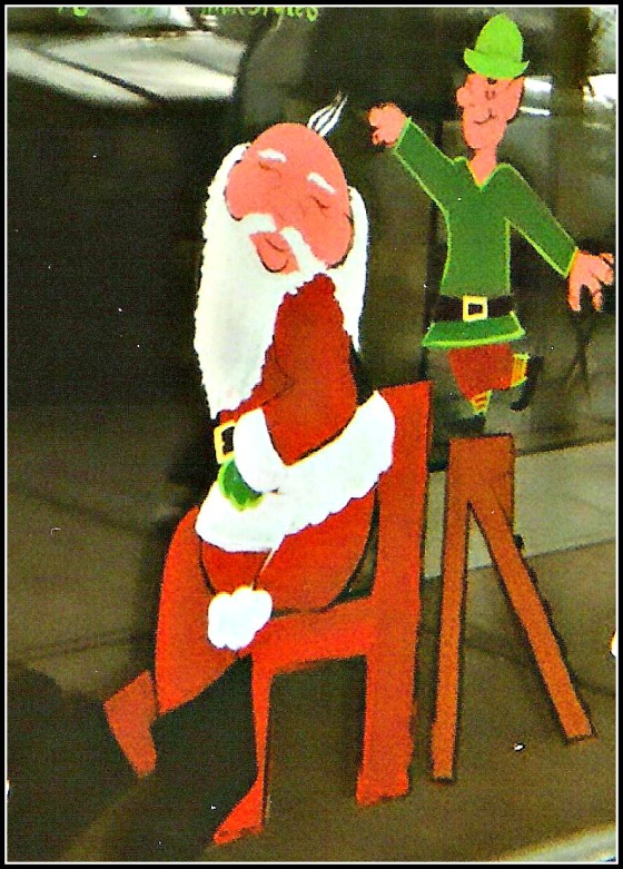 window painting of Santa being given a hair cut by an elf on a ladder.